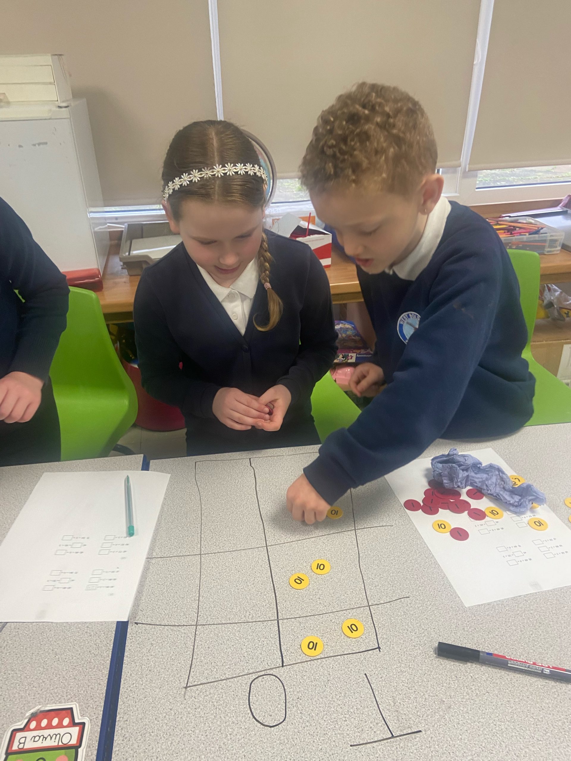 Year 4 children working on division using place value charts and counters