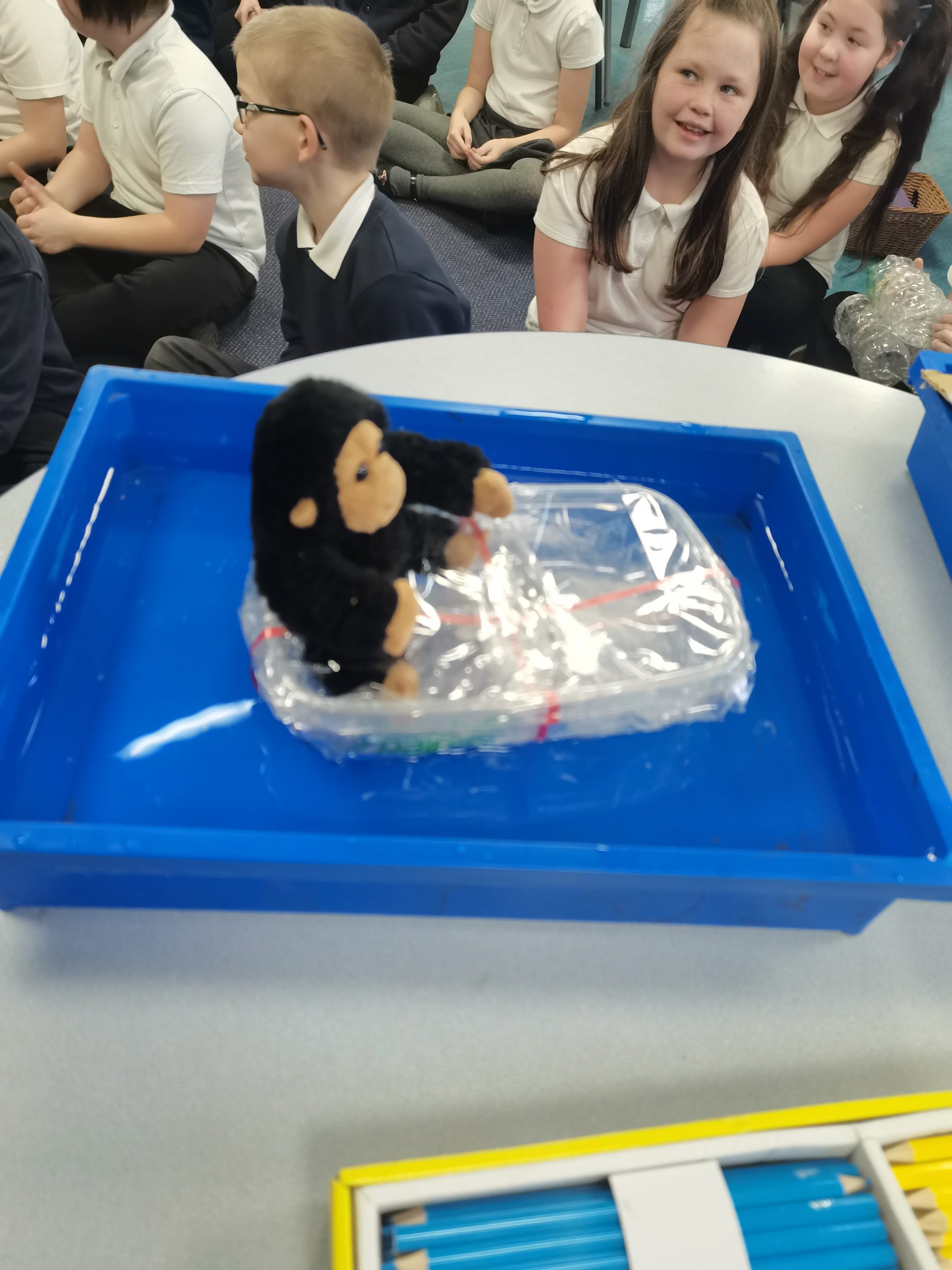 Year 4 children testing out their rafts for their toy gorilla