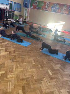 Reception children taking part in their yoga session