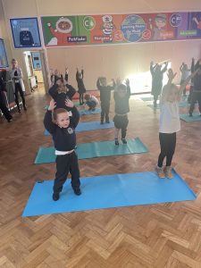Reception children taking part in their yoga session