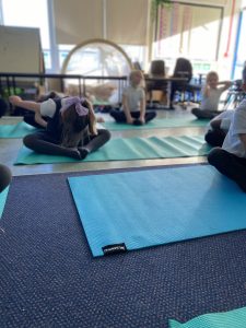 Year 1 children taking part in their yoga session