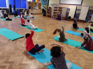 Year 3 children taking part in their yoga session