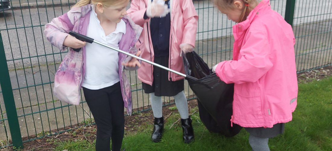 Year 1 children taking part in the Big School Clean by picking up litter on our school grounds