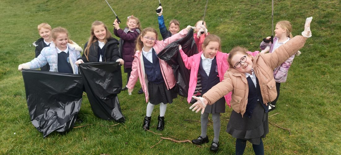 Year 1 children taking part in the Big School Clean by picking up litter on our school grounds