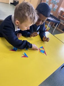 Year 1 completing an NRICH activity to extend their knowledge of number bonds to ten