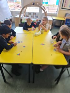Year 1 completing an NRICH activity to extend their knowledge of number bonds to ten