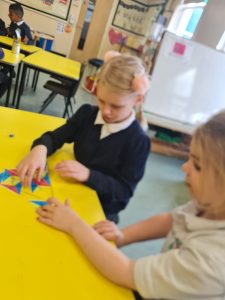 Year 1 completing an NRICH activity to extend their knowledge of number bonds to ten