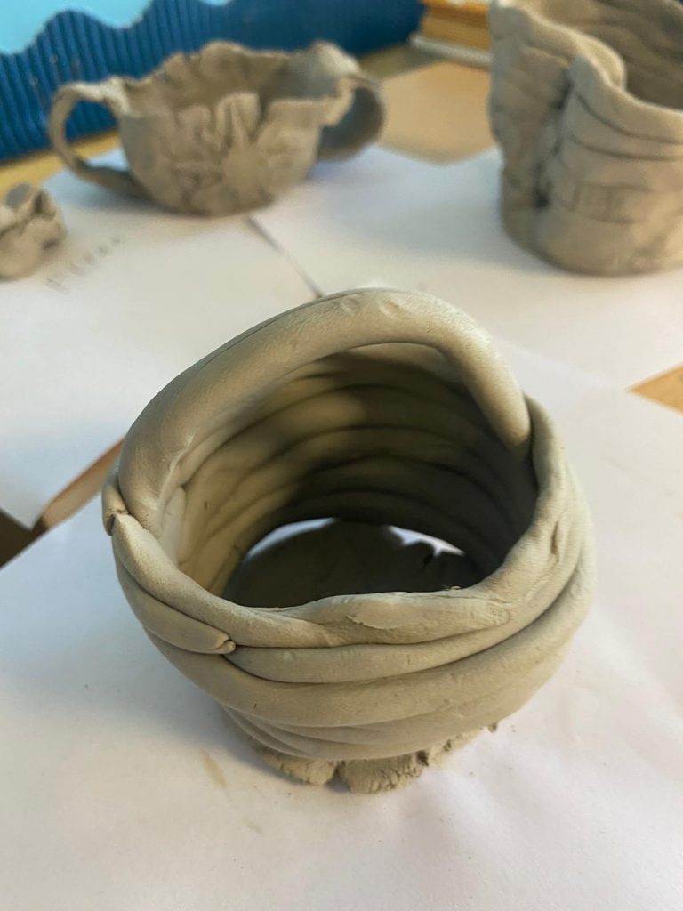 Year 6 children making clay pots