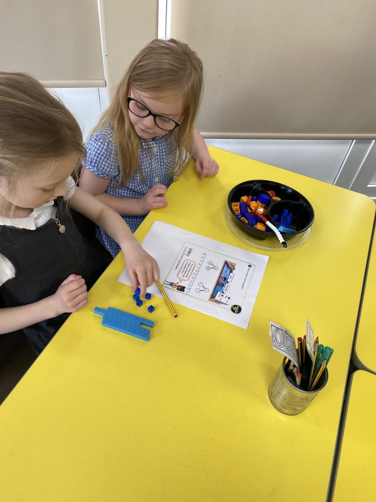Class 4 working on using practical resources to help solve maths problems