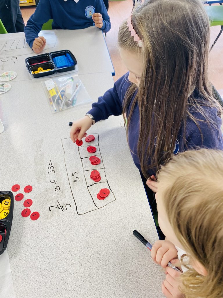 Children in Year 3 working out fractions of amounts using bar models and place value counters