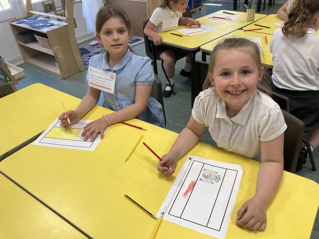 Year 1 children making spanish flags in Spanish Club