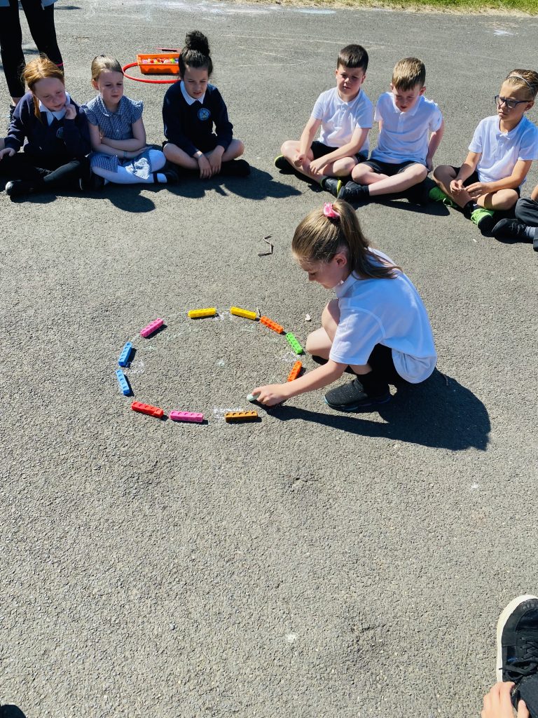Year 3 children taking part in maths outside today