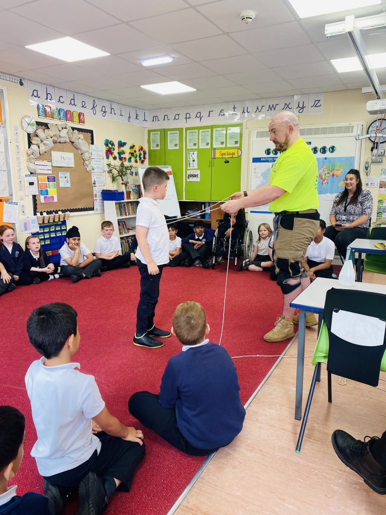 Year 3 enjoying their rainforest workshop with Rob from ZooLab