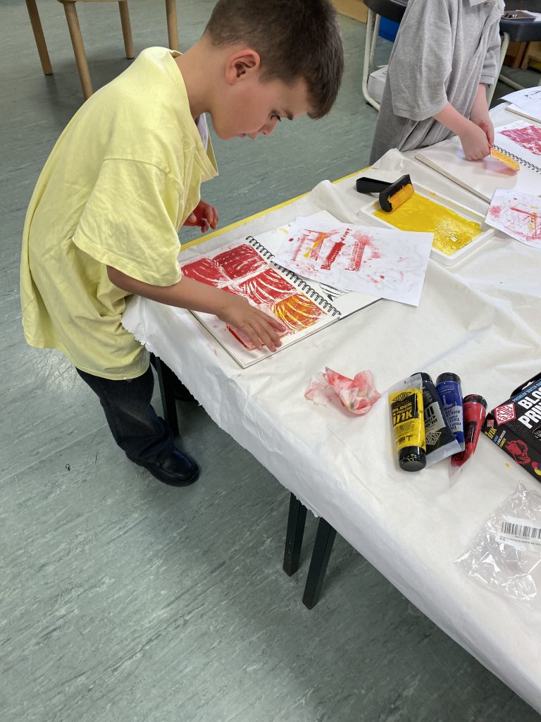 Year 1 children exploring block printing in Art