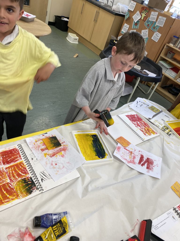 Year 1 children exploring block printing in Art