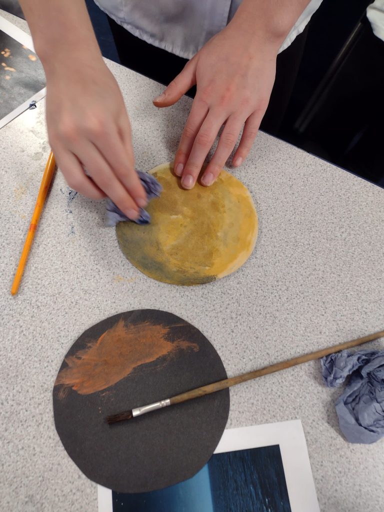 Year 5 children creating their paintings of the moon