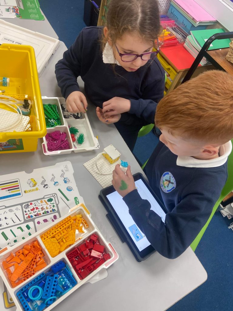 Year 3 children building their Lego models using the SPIKE kit