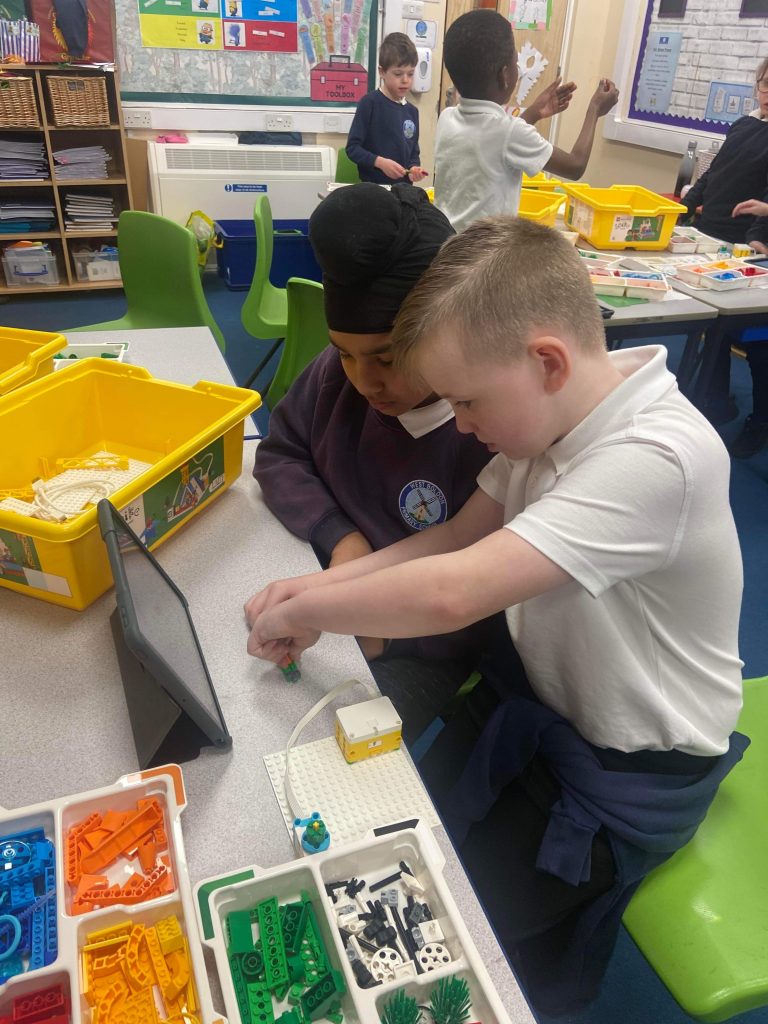 Year 3 children building their Lego models using the SPIKE kit